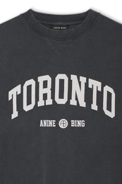 Washed black crewneck sweatshirt with "TORONTO" and "ANNE BING" text printed in white across chest.