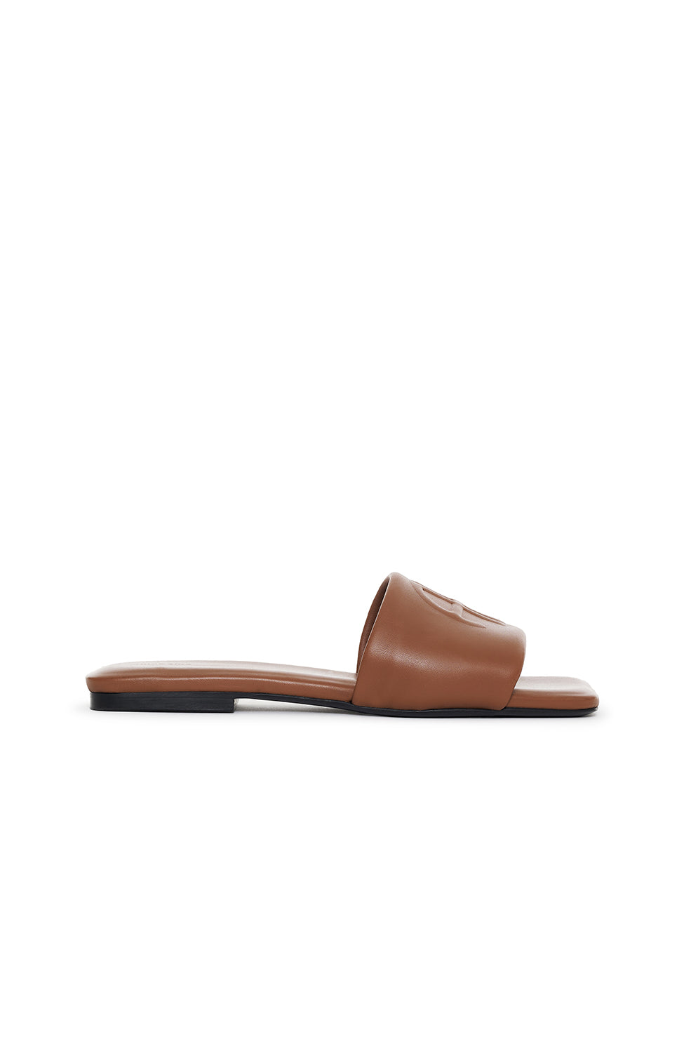 Cognac leather slide sandal with padded upper and flat sole.